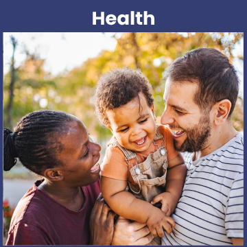 Two parents smile at their baby who they are holding between them.